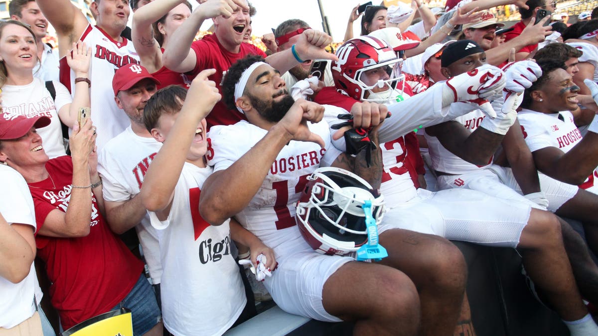 Wide receiver Elijah Sarratt #13 of the Indiana Hoosiers celebrates with fans after the matchup against Iowa. (Photo by Matthew Holst/Getty Images)