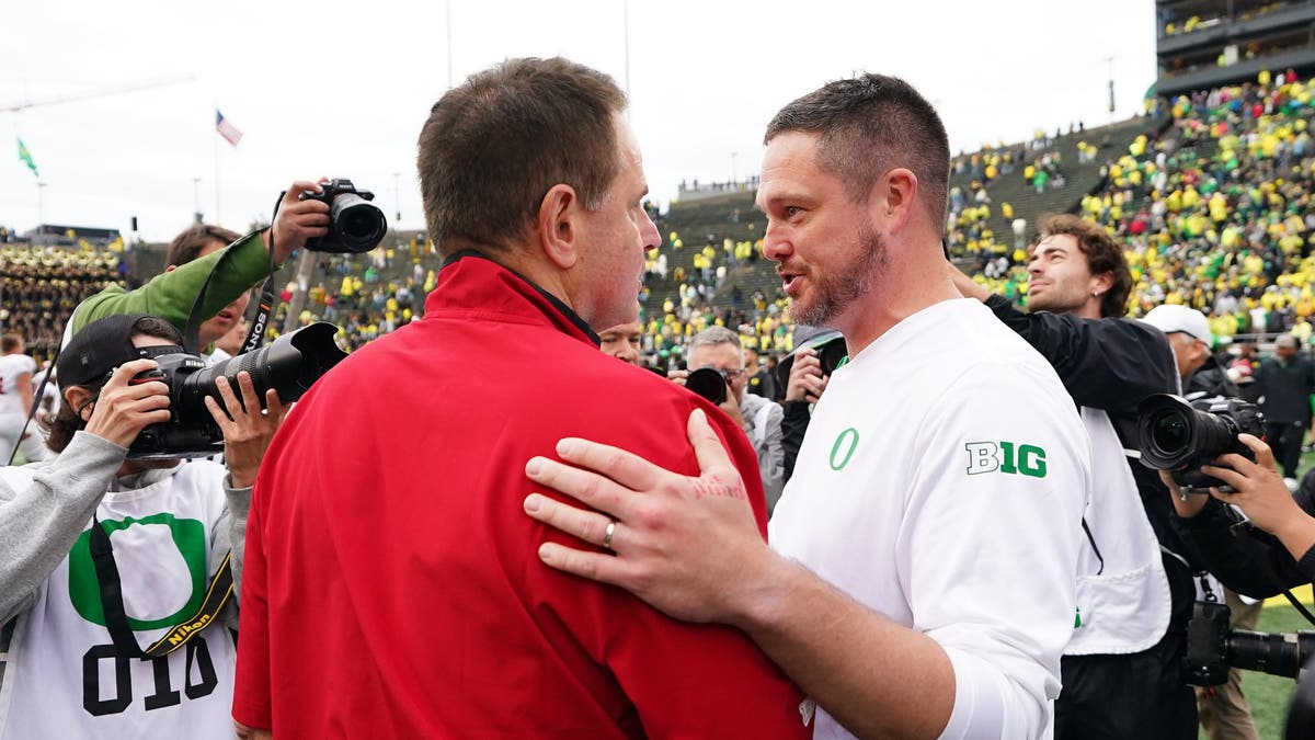 Head coach Curt Cignetti of the Indiana Hoosiers and head coach Dan Lanning of the Oregon Ducks meet at midfield following their game at Autzen Stadium. (Photo by Soobum Im/Getty Images)