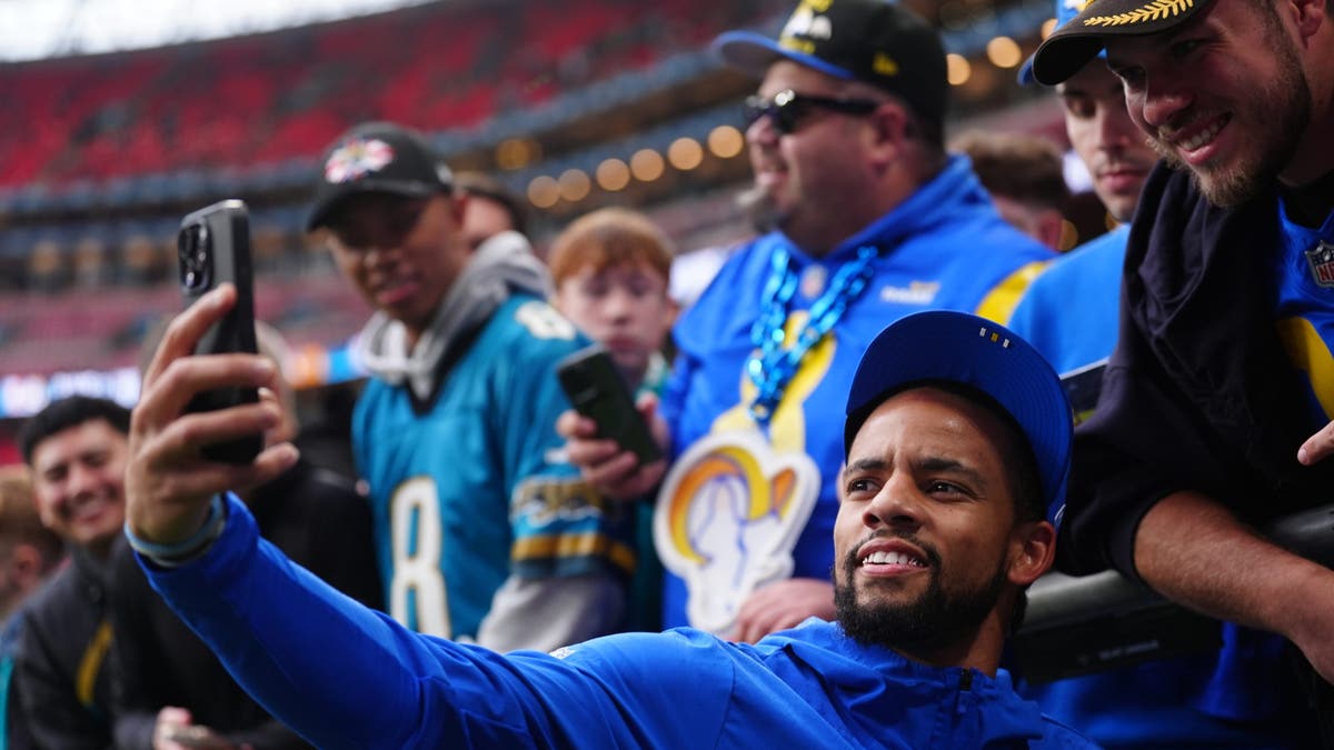 Rams player Cobie Durant greets fans before the game.