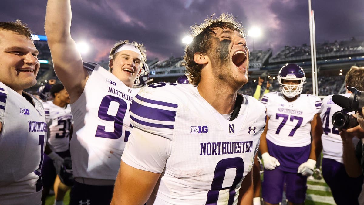 Preston Stone #8 of the Northwestern Wildcats celebrates with the team after a game against Penn State. (Photo by Isaiah Vazquez/Getty Images)