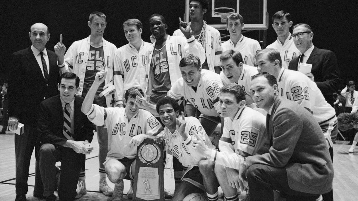Team group shot of the UCLA University players after they won the NCAA Title beating Dayton. Lew Alcindor shown in center rear and coach John Wooden is on right rear.