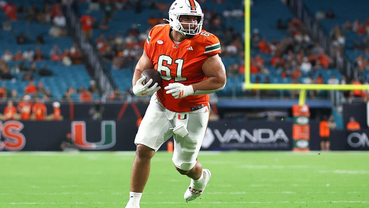 Francis Mauigoa #61 of the Miami Hurricanes carries the ball for a touchdown against the Syracuse Orange during the fourth quarter of the game at Hard Rock Stadium on November 08, 2025 in Miami Gardens, Florida. (Photo by Megan Briggs/Getty Images)