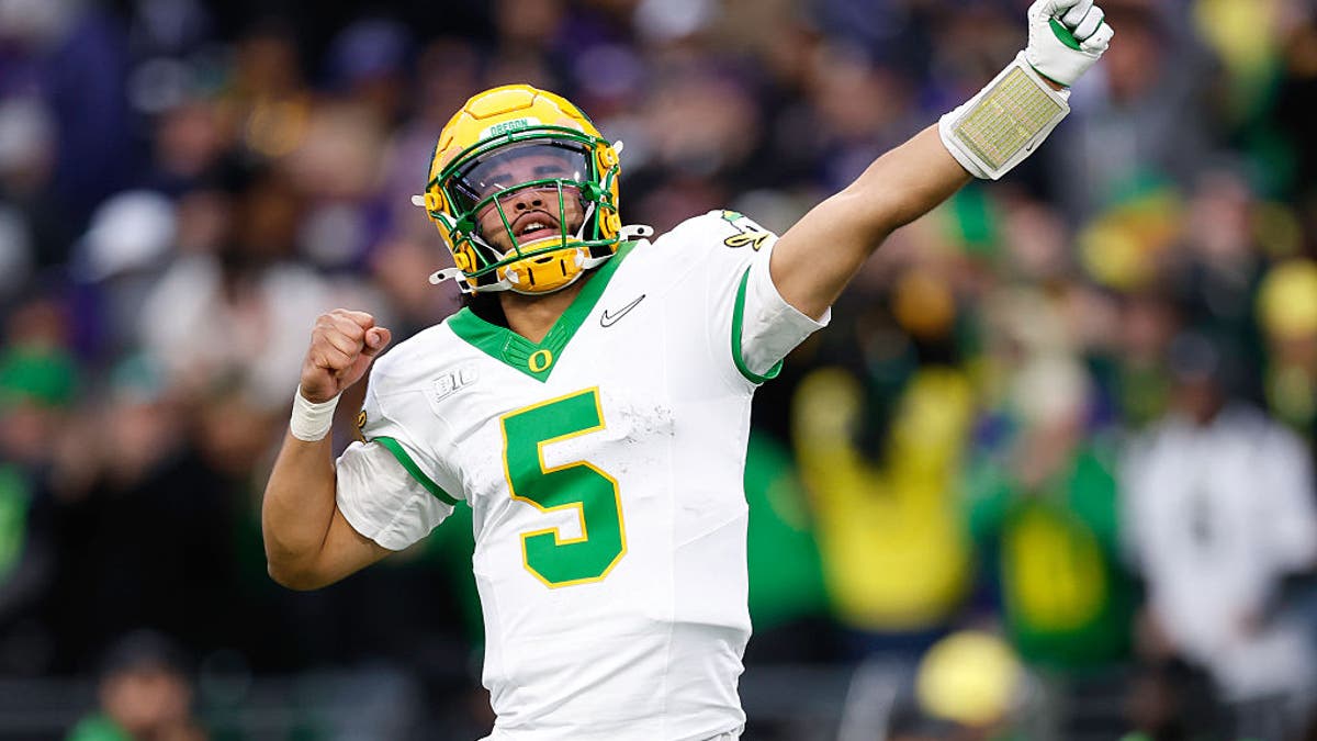 Dante Moore #5 of the Oregon Ducks gestures after a touchdown during the fourth quarter of the game against the Washington Huskies at Husky Stadium on November 29, 2025 in Seattle, Washington. (Photo by Alika Jenner/Getty Images)