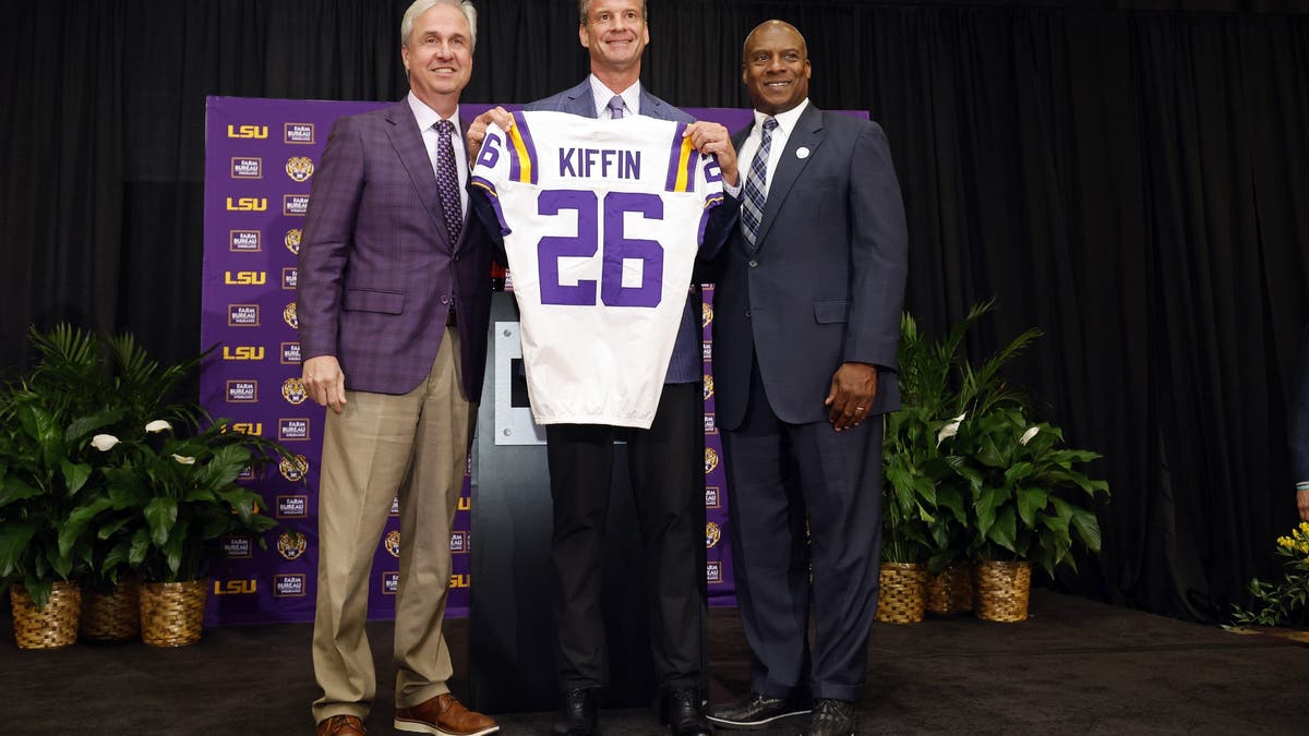 Lane Kiffin with LSU president Dr. Wade Rousse and LSU interim athletic director Verge Ausberry at a press conference as he's introduced as the Tigers' new head football coach. (Photo by Tyler Kaufman/Getty Images)