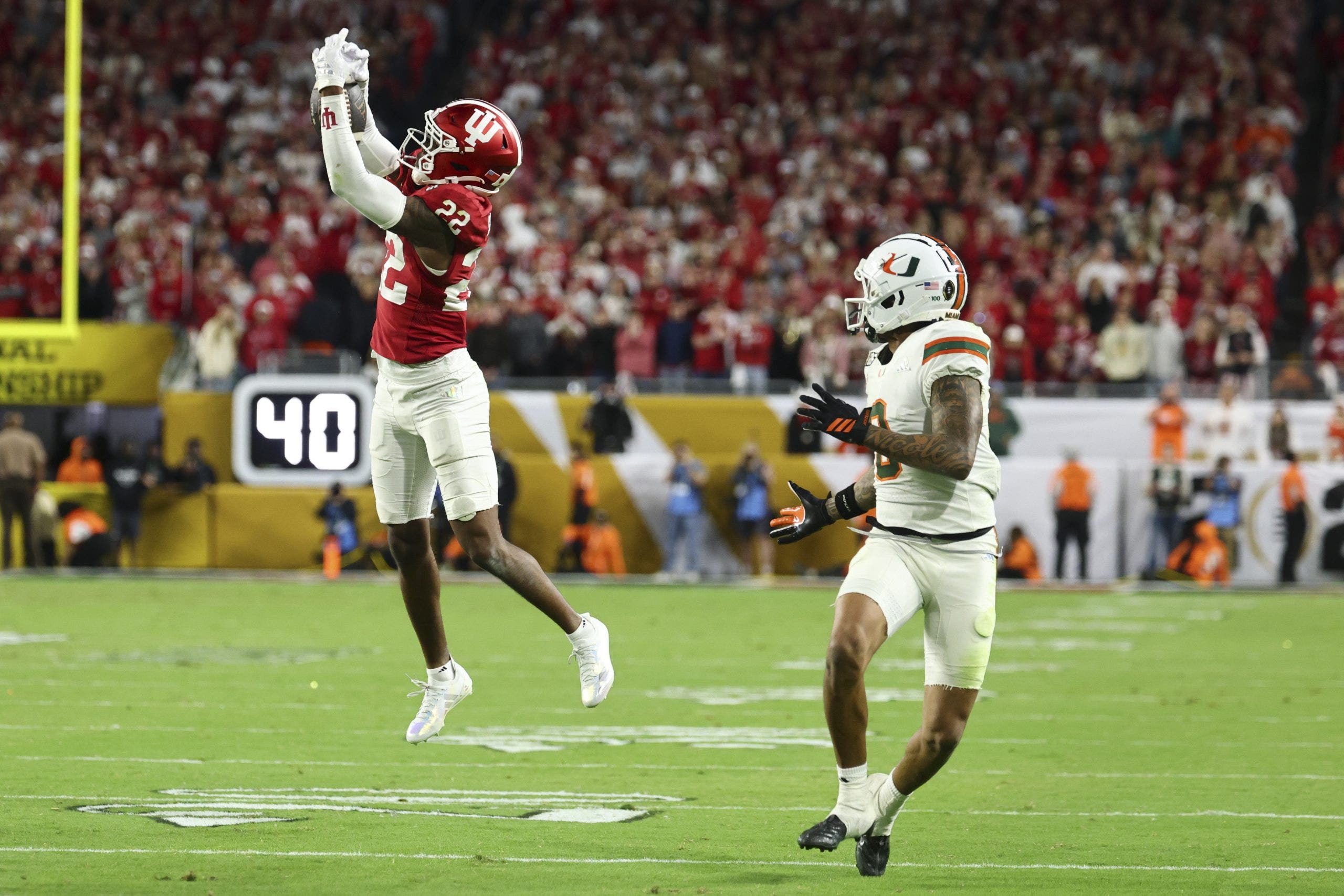 MIAMI GARDENS, FLORIDA - JANUARY 19: Jamari Sharpe #22 of the Indiana Hoosiers intercepts a pass intended for Keelan Marion #0 of the Miami Hurricanes during the fourth quarter in the 2026 College Football Playoff National Championship at Hard Rock Stadium on January 19, 2026 in Miami Gardens, Florida. (Photo by Jamie Schwaberow/Getty Images)