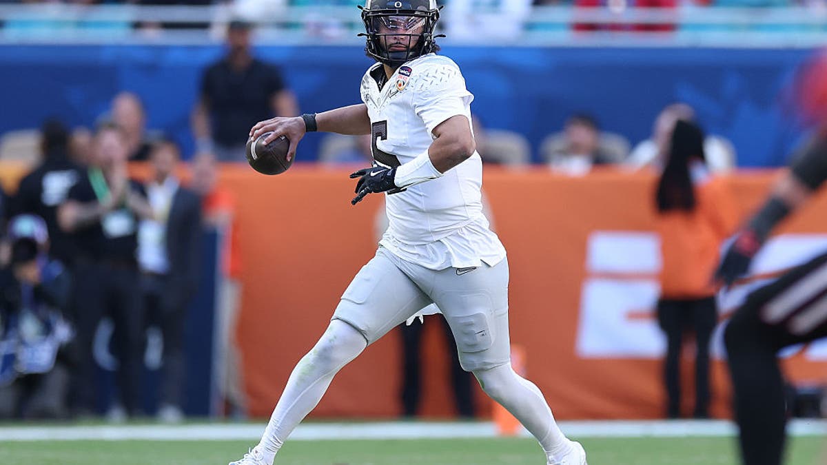 Dante Moore #5 of the Oregon Ducks looks to pass against the Texas Tech Red Raiders during the second quarter of the 2025 College Football Playoff Quarterfinal at the Capital One Orange Bowl at Hard Rock Stadium on January 01, 2026 in Miami Gardens, Florida. (Photo by Kevin C. Cox/Getty Images)