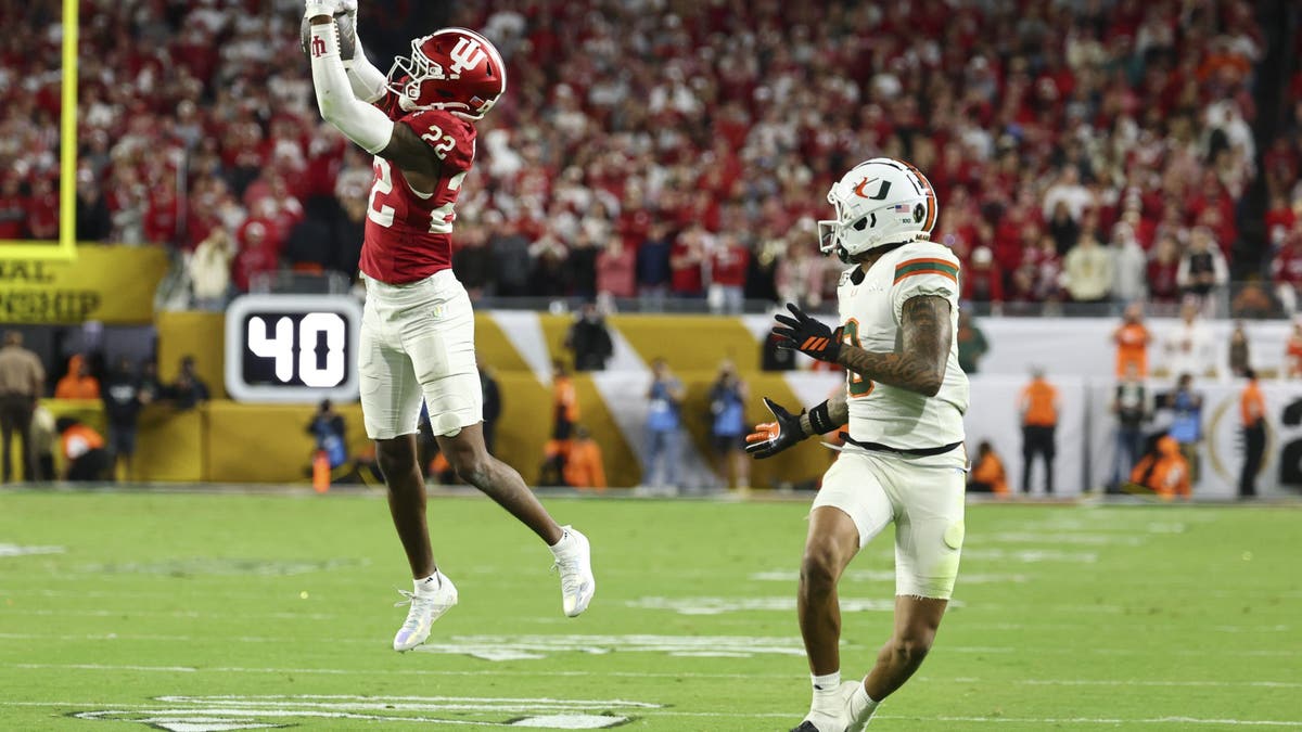 MIAMI GARDENS, FLORIDA - JANUARY 19: Jamari Sharpe #22 of the Indiana Hoosiers intercepts a pass intended for Keelan Marion #0 of the Miami Hurricanes during the fourth quarter in the 2026 College Football Playoff National Championship at Hard Rock Stadium on January 19, 2026 in Miami Gardens, Florida. (Photo by Jamie Schwaberow/Getty Images)