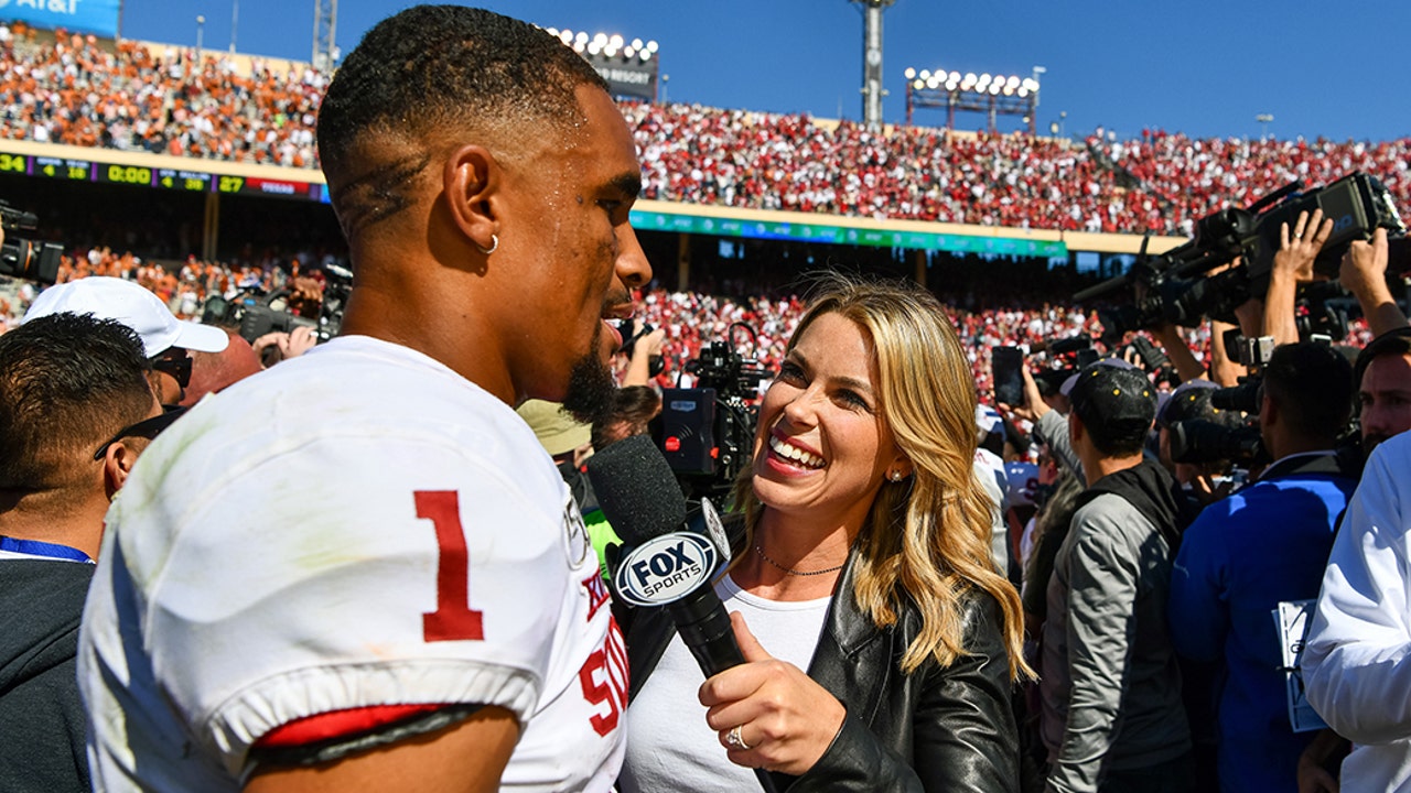 Jenny Taft with Oklahoma Quarterback Jalen Hurts