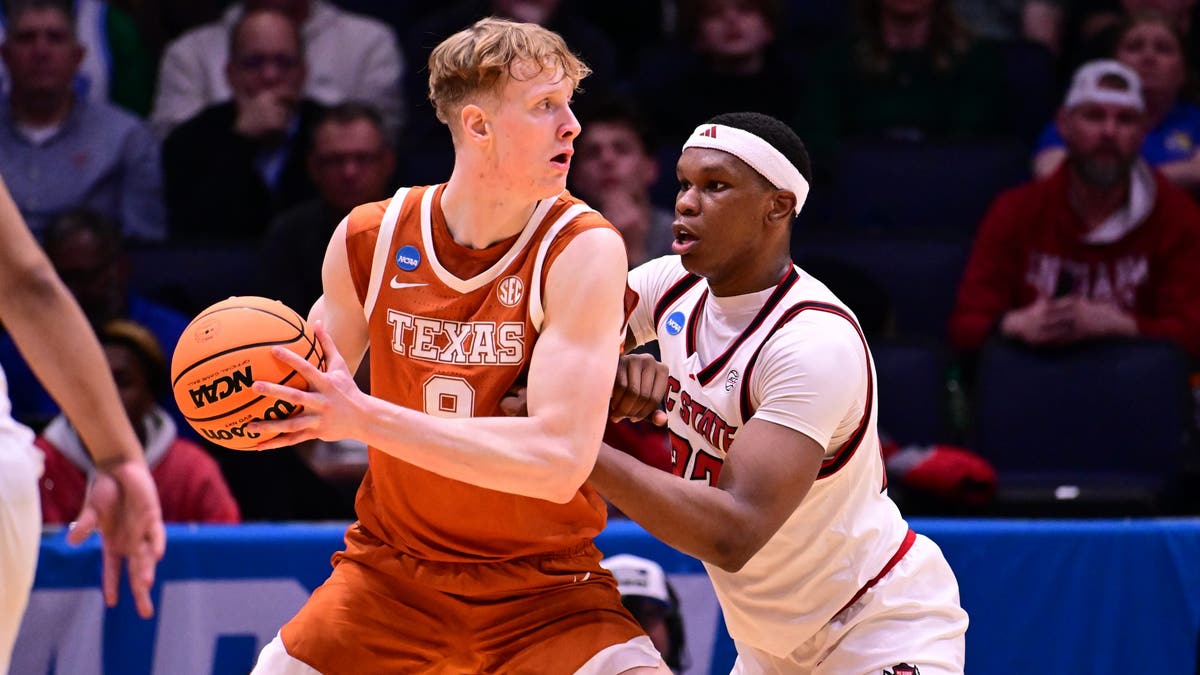 Matas Vokietaitis of the Texas Longhorns posts up against Ven-Allen Lubin of NC State. (Photo by Ben Solomon/NCAA Photos via Getty Images)