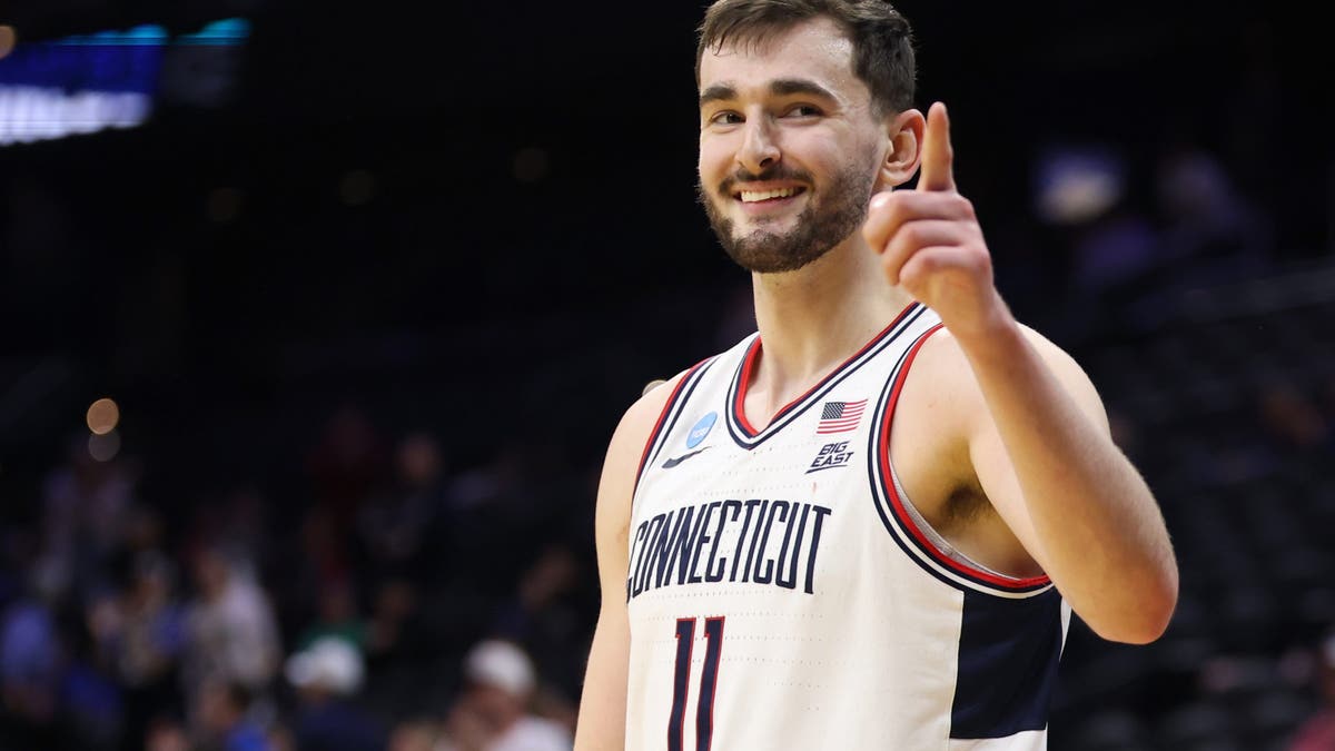 Alex Karaban #11 of the UConn Huskies celebrates after defeating UCLA (Photo by Emilee Chinn/Getty Images)