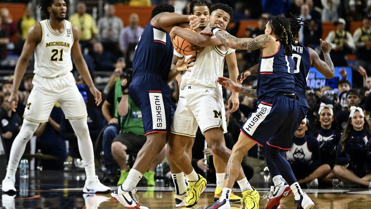 Trey McKenney of the Michigan Wolverines battles for control of the ball in the national championship. (Photo by Brett Wilhelm/NCAA Photos via Getty Images)
