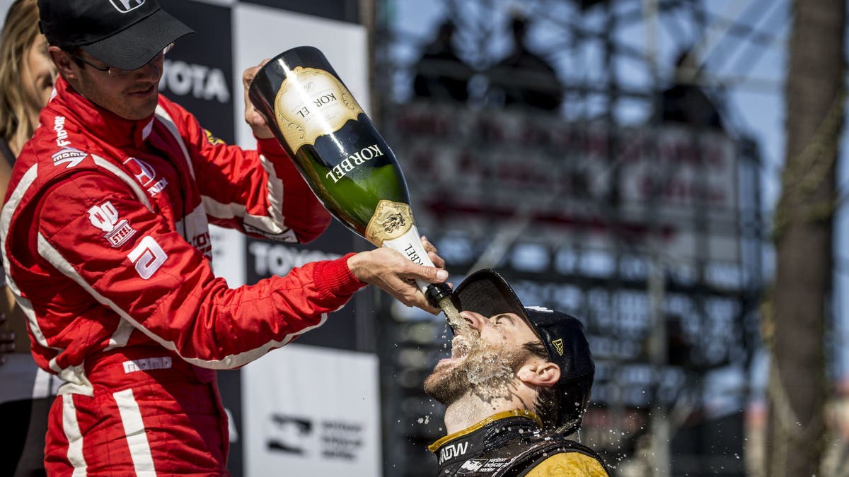 Runner-up Sebastien Bourdais pours champagne on race winner James Hinchcliffe after the 2017 Grand Prix of Long Beach.  (Photo by Brian Cleary/Getty Images)