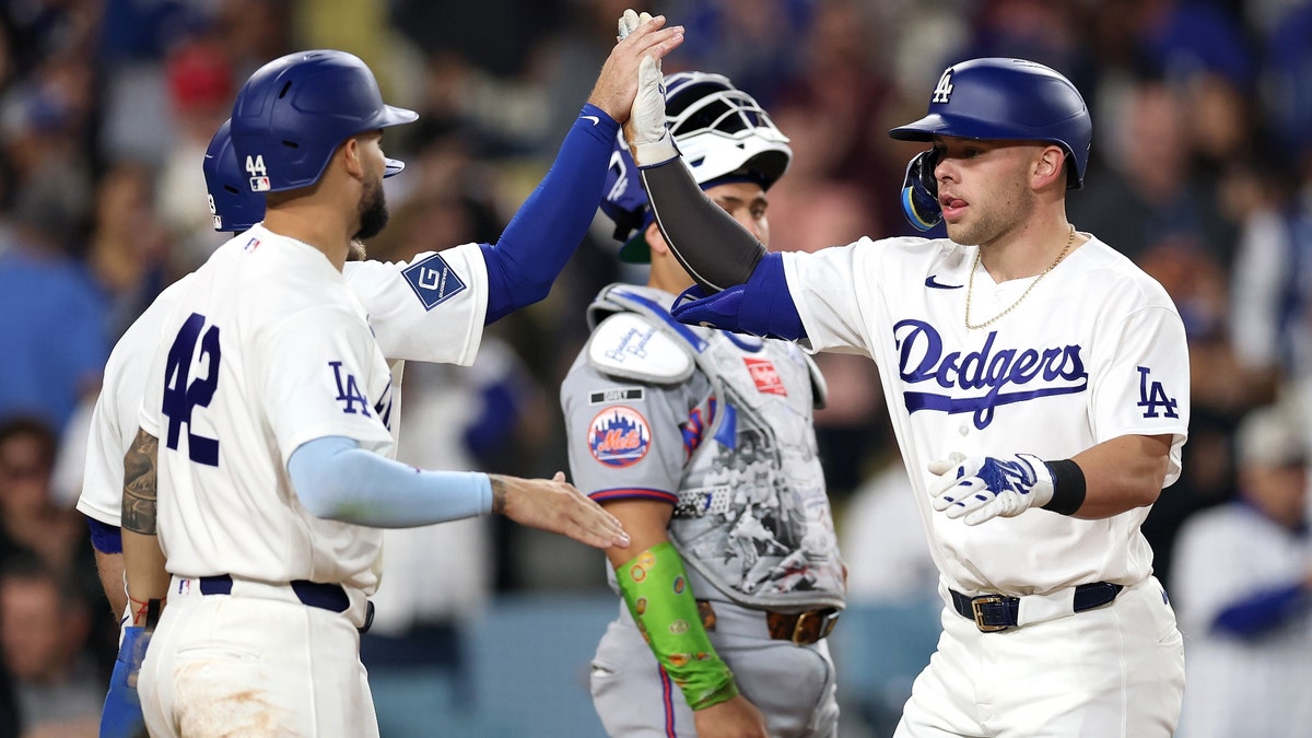 Dalton Rushing (right) celebrates his grand slam on Wednesday night. (Luke Hales/Getty Images)