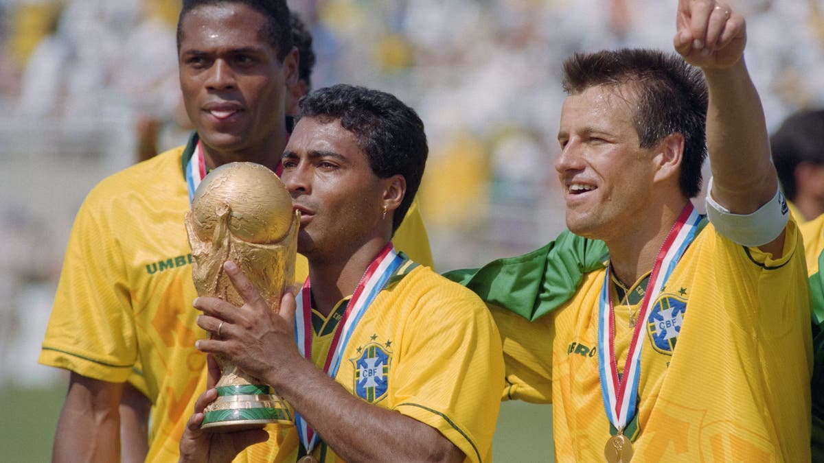 Brazil with the 1994 World Cup trophy (Photo by Daniel GARCIA / AFP via Getty Images)