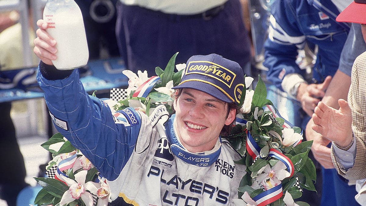 Jacques Villeneuve with bottle of milk in hand during his celebration. 