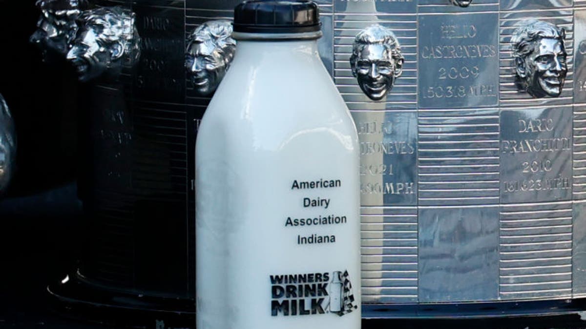 A bottle of milk rests on the yard of bricks next to the engraved faces of former Indianapolis 500 winners that appear on the Borg-Warner Trophy.