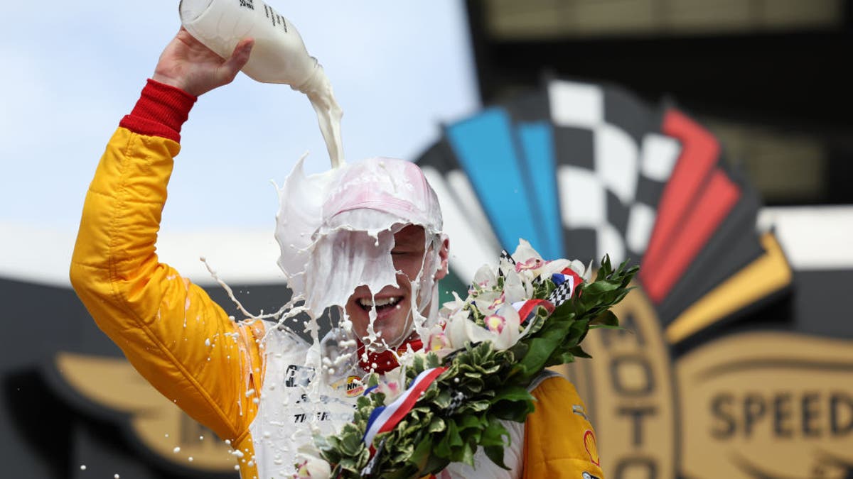 Josef Newgarden celebrated by pouring milk on his head after winning the 107th Running of the Indianapolis 500.