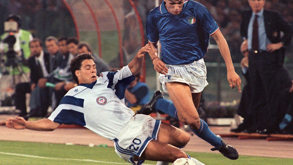 Italian defender Paolo Maldini is tackled by USA midfielder Paul Caliguri during the 1990 World Cup (BOB PEARSON/AFP via Getty Images)