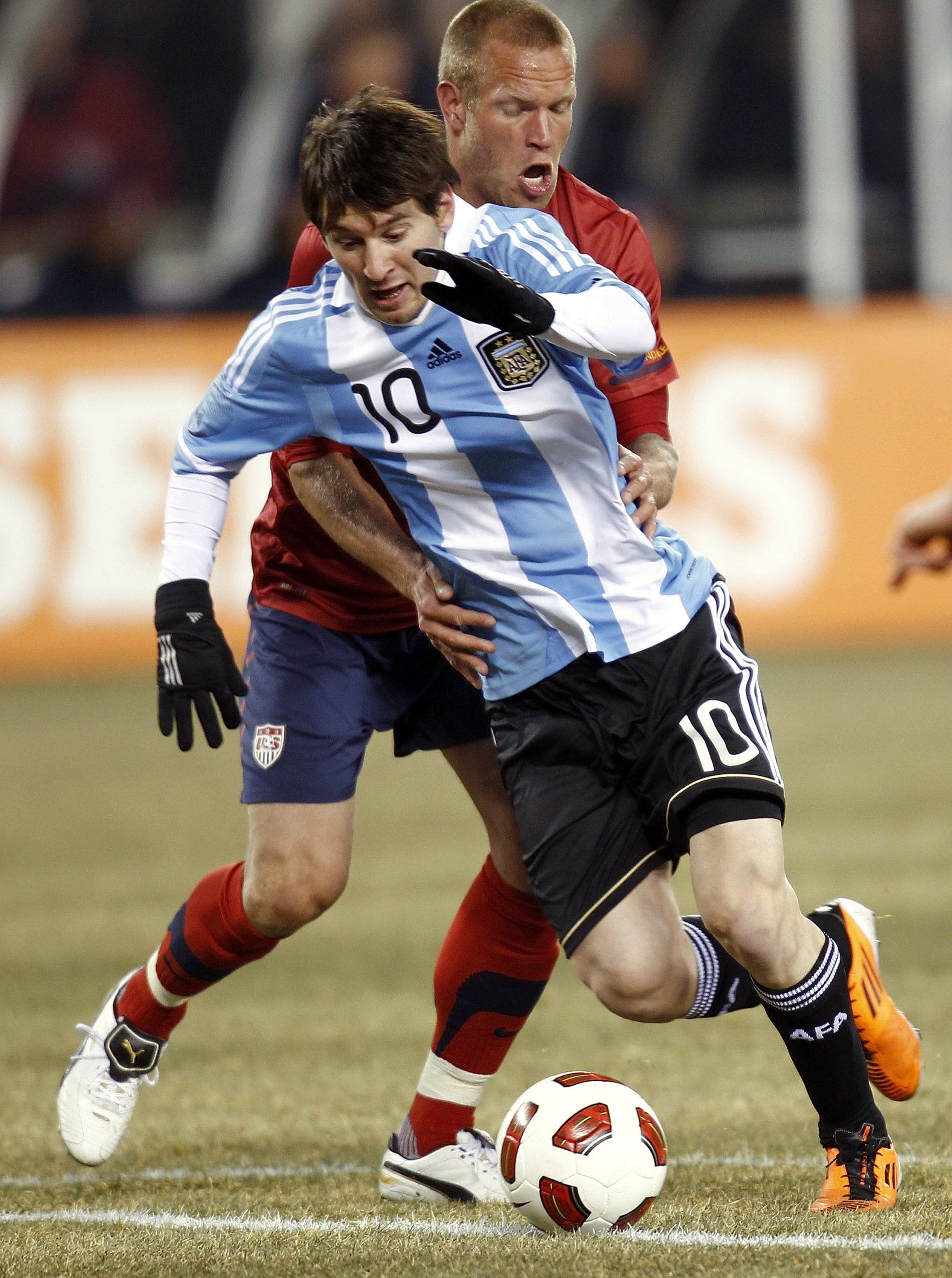 Lionel Messi tangles with Jay DeMerit back on March 26, 2011 in East Rutherford, New Jersey. (Jeff Zelevansky/Getty Images)