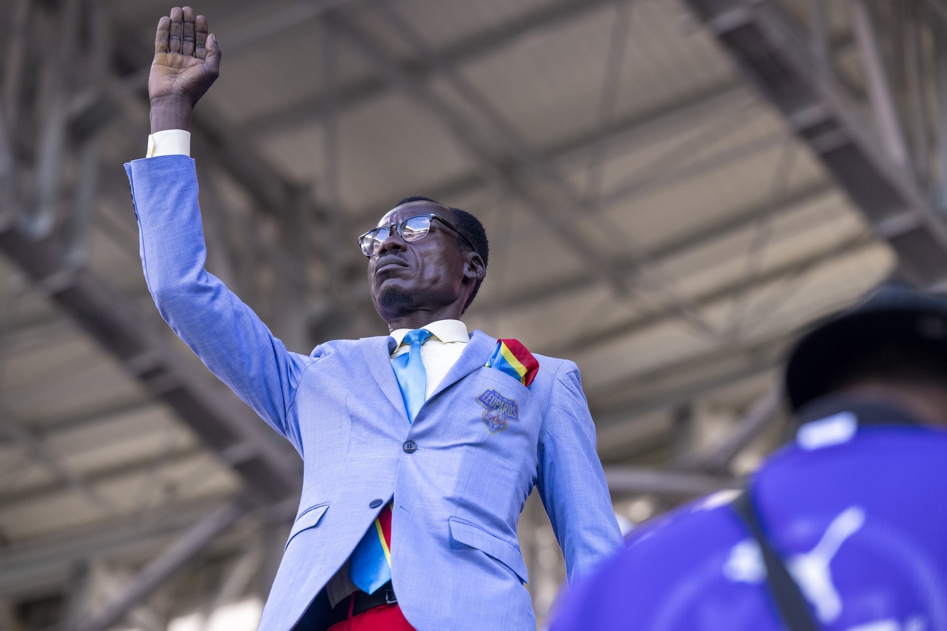Congolese supporter Michel Nkuka Mboladinga re-enacts the iconic pose of former Congolese Prime Minister and independence leader Patrice Lumumba to draw attention to his country's history during the match. Lumumba was executed by Belgian soldiers on January 17, 1961, and the gesture mirrors his memorial statue in Kinshasa. (Photo by Abu Adem Muhammed/Anadolu via Getty Images)