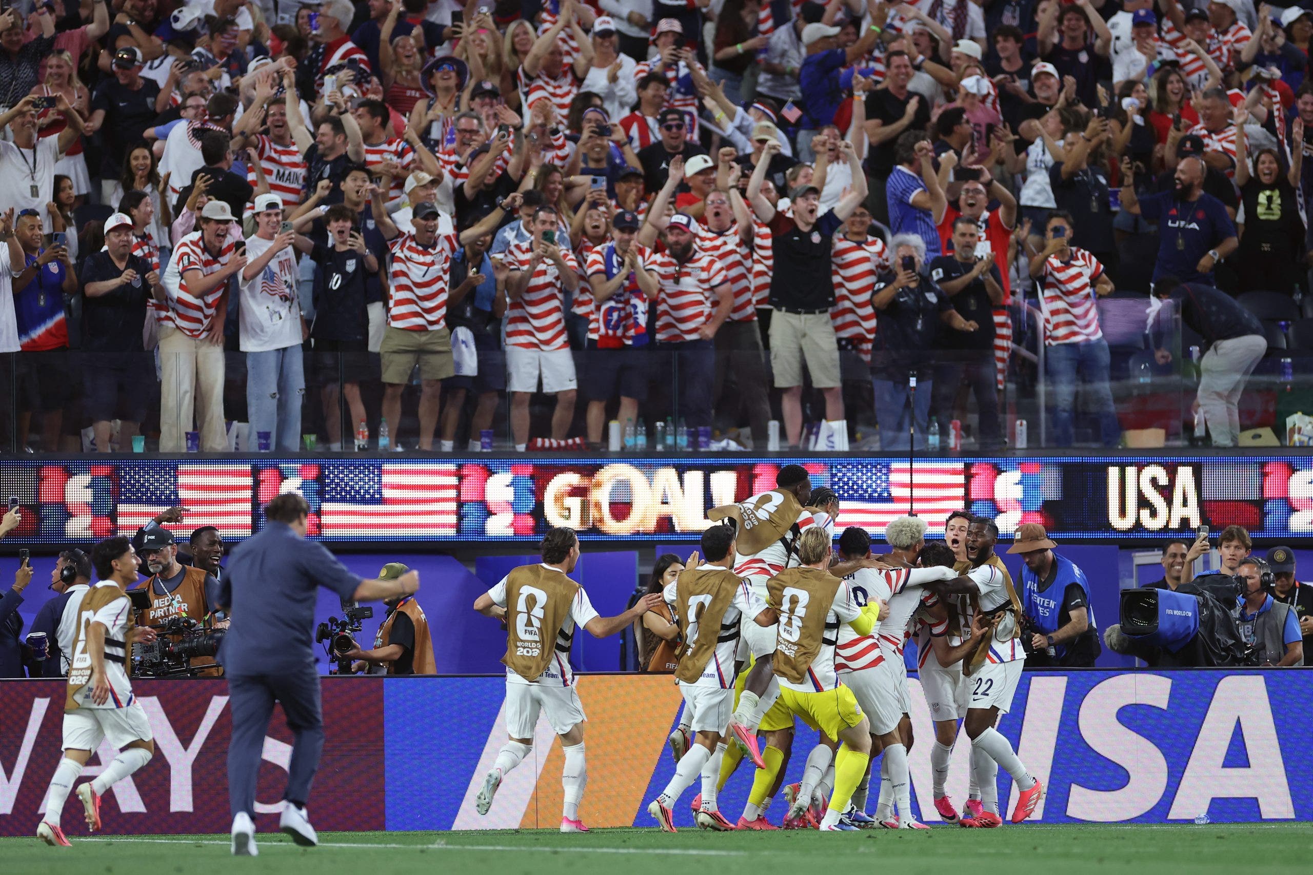 The U.S. celebrates Gio Reyna's goal against Paraguay, with Mauricio Pochettino running on the field to join in. (Sarah Stier - FIFA/FIFA via Getty Images)