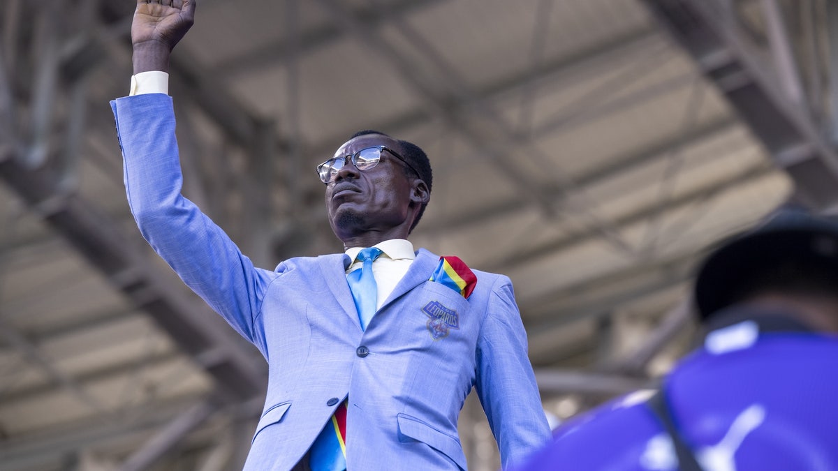 Congolese supporter Michel Nkuka Mboladinga re-enacts the iconic pose of former Congolese Prime Minister and independence leader Patrice Lumumba to draw attention to his country's history during the match. Lumumba was executed by Belgian soldiers on January 17, 1961, and the gesture mirrors his memorial statue in Kinshasa. (Photo by Abu Adem Muhammed/Anadolu via Getty Images)