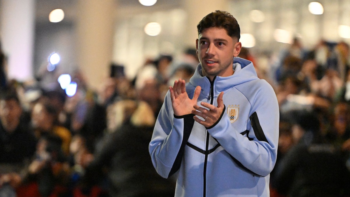 Uruguay star Federico Valverde greets fans at the airport before departing for the World Cup. (Santiago Mazzarovich / AFP via Getty Images)